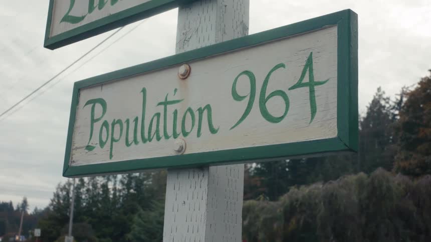 A sign indicates the population of lummi island as 964