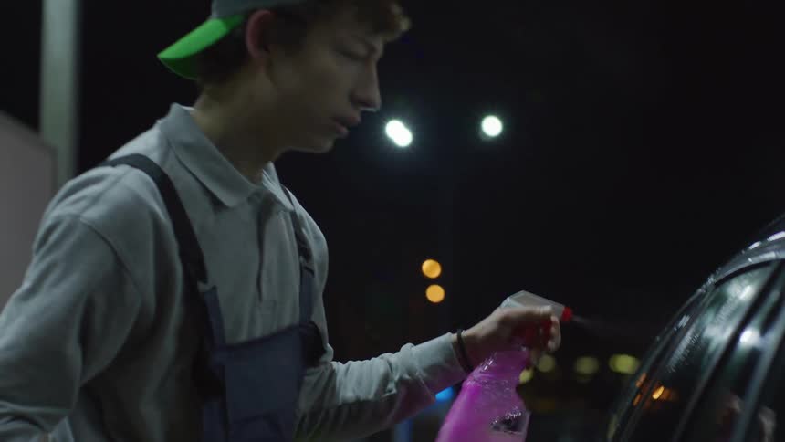 A footage of a person cleaning a car