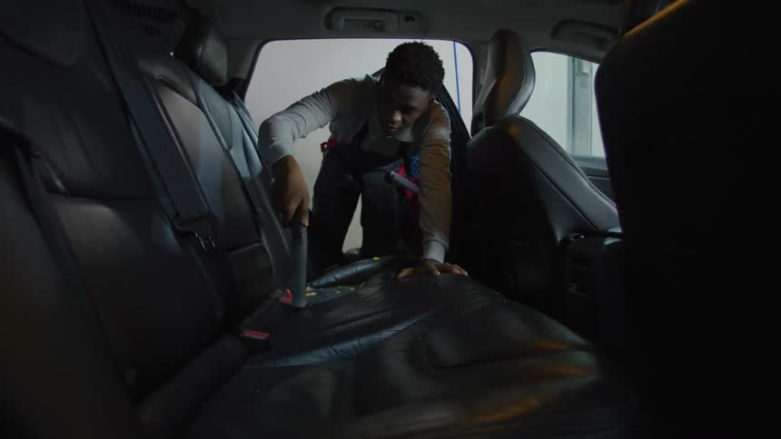 A clip of a person cleaning a car interior