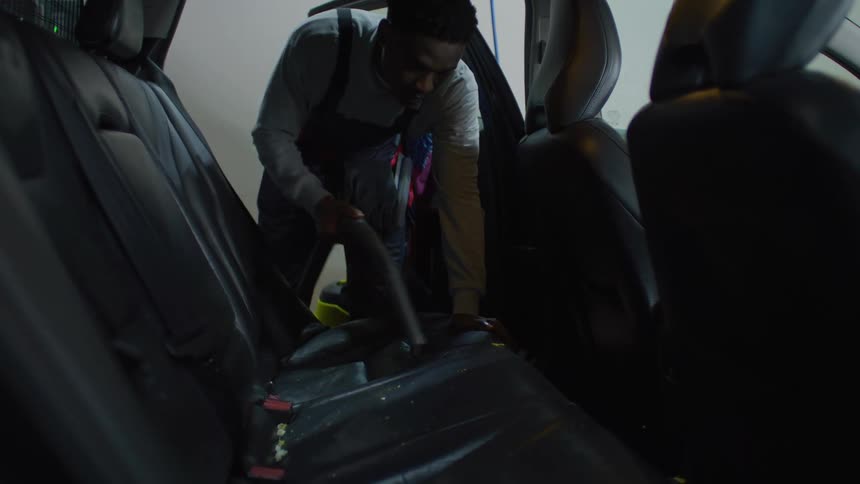 A footage of a person cleaning a car