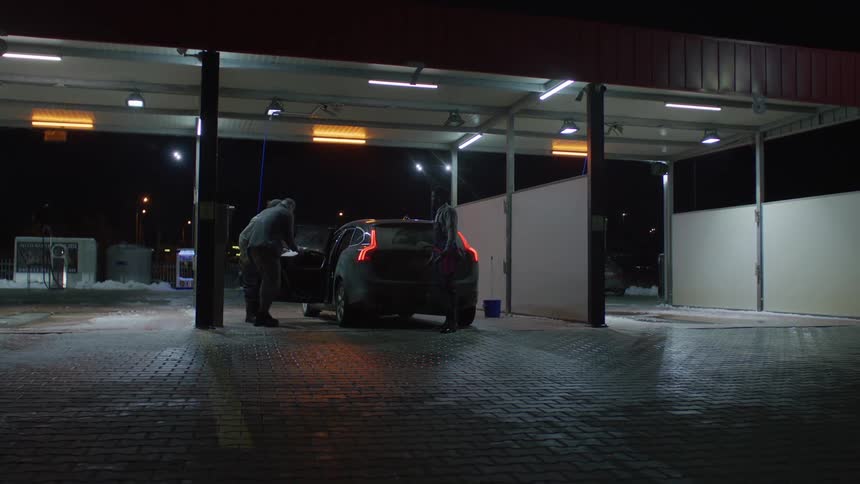 Car being put through a car wash at night
