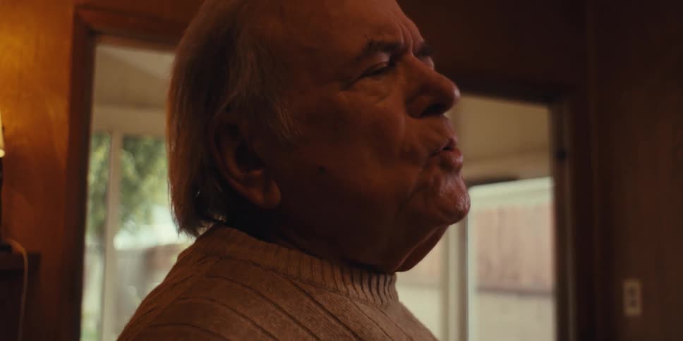 Elderly person mopping a room happily