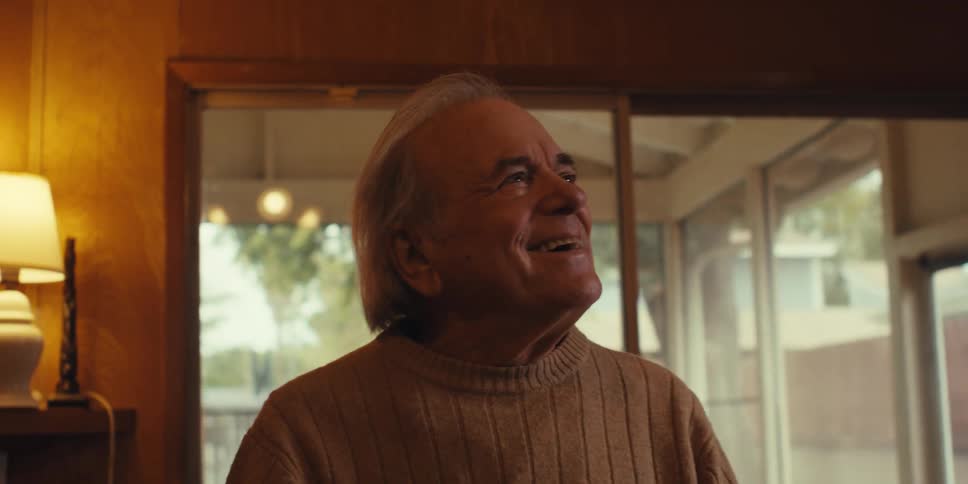 Happy senior man standing in living room