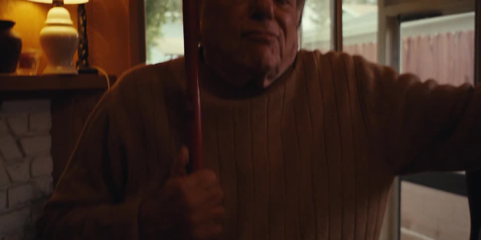Elderly man cleaning the house dancing and singing