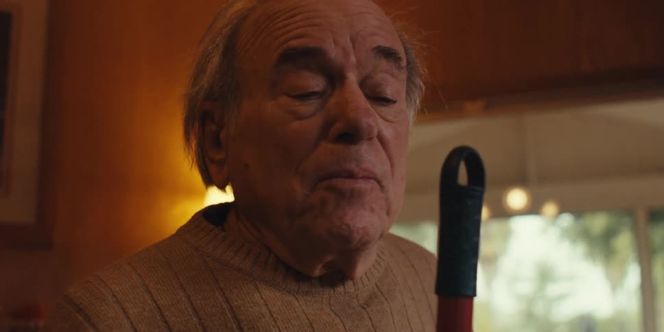 A footage of an elderly man singing indoor