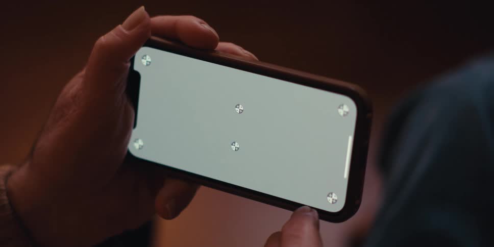 Pair of hands interacting with an iphone from the side