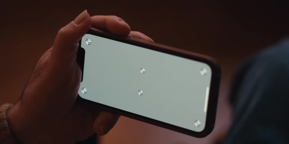 Close up of a pair of hands interacting with a smartphone
