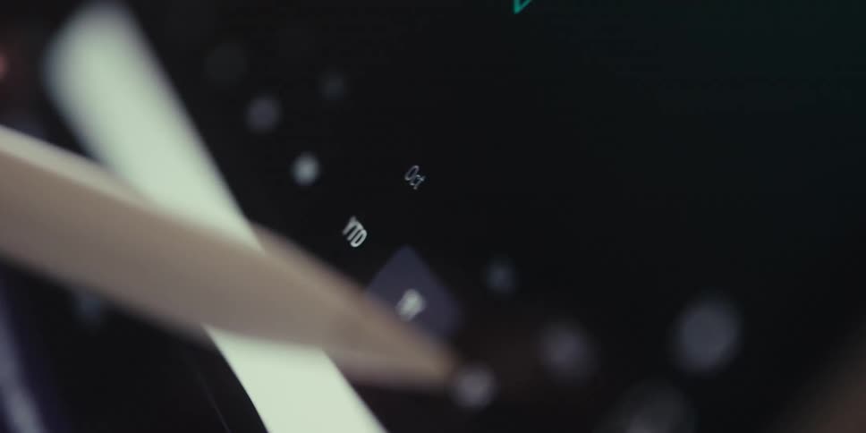A womans hand holding a stylus near a digital screen with floating pixellike elements and a jagged graph line in the background creating a futuristic and data driven aesthetic