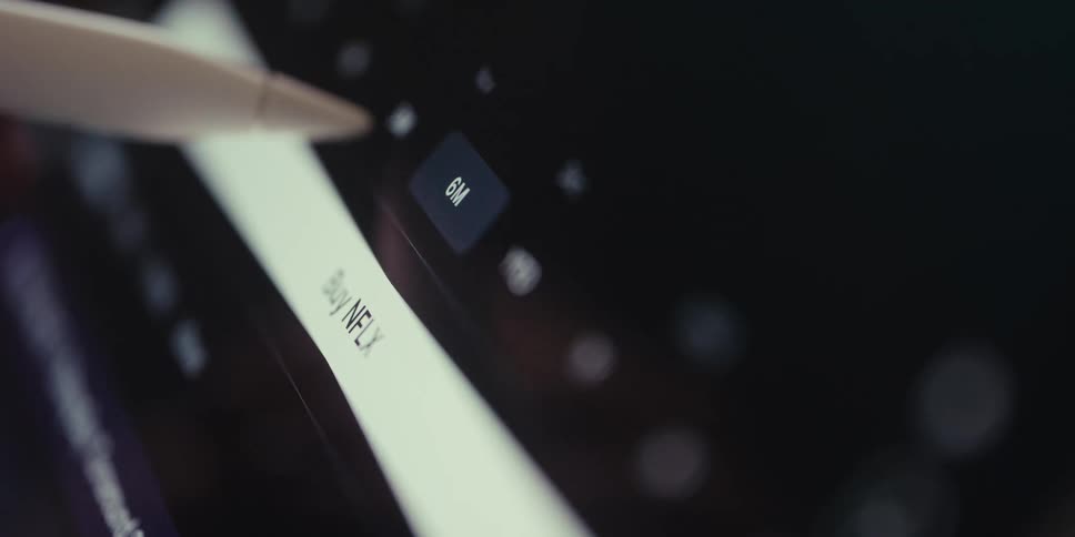 An apple pencil hovers over a stock app to buy netflix shares transitioning to a confirmation screen