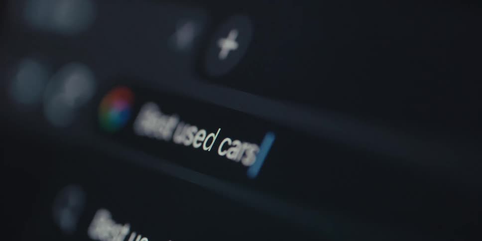 Closeup of a screen displaying a google browser search bar and text being typed