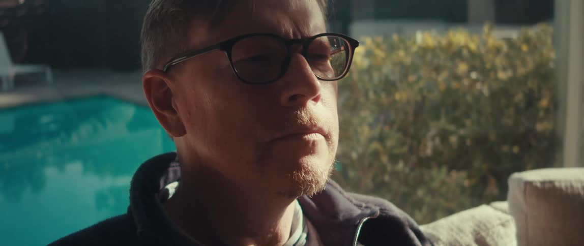 Portrait of a man with glasses sitting thoughtfully