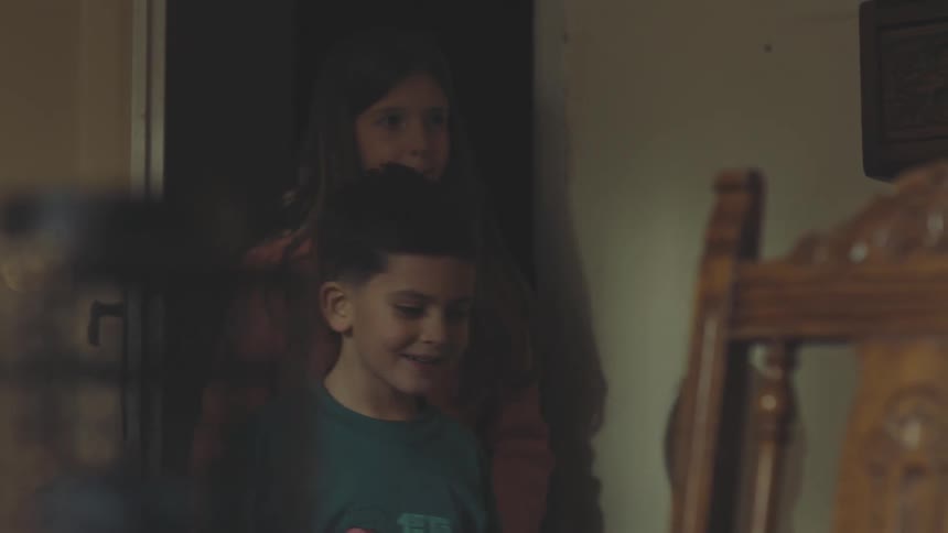 Boy and girl opening the door and entering a room in the house