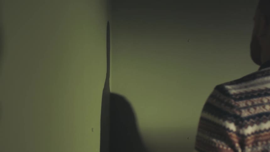 Man measuring the walls of a house with a tape measure