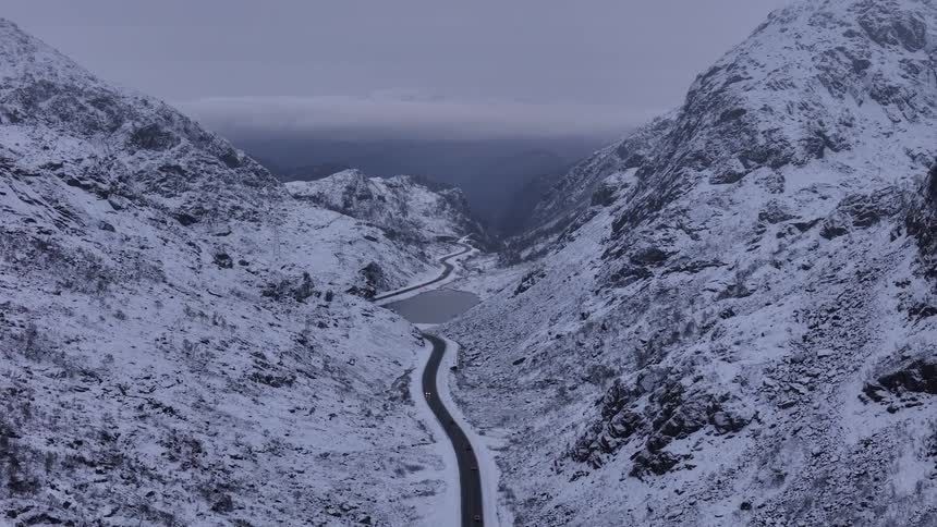 A road runs through the snow covered mountains