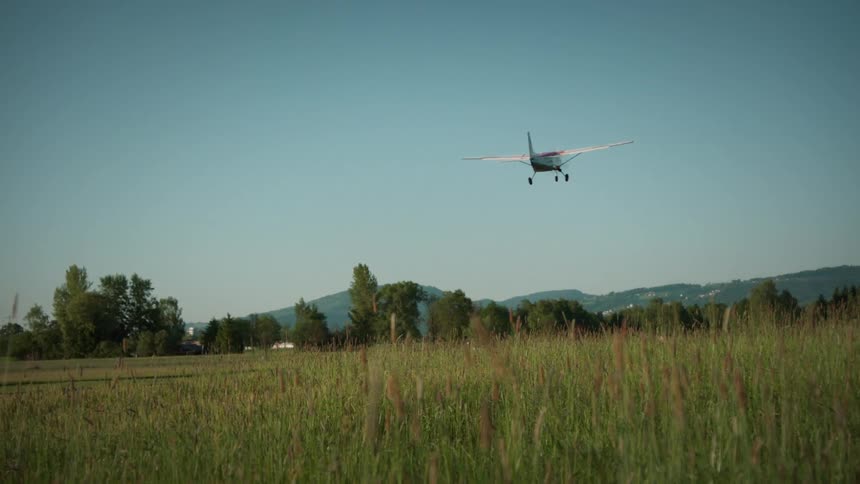 A redandorange plane accelerates along the tarmac before lifting into the sky