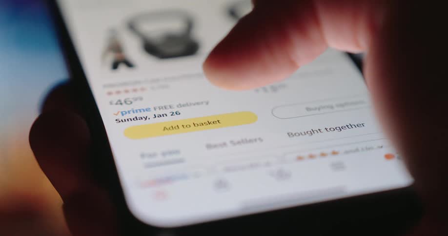 Person adds an item to their basket while shopping online via a smartphone