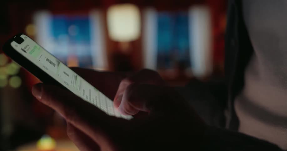Pair of hands typing on a smartphone