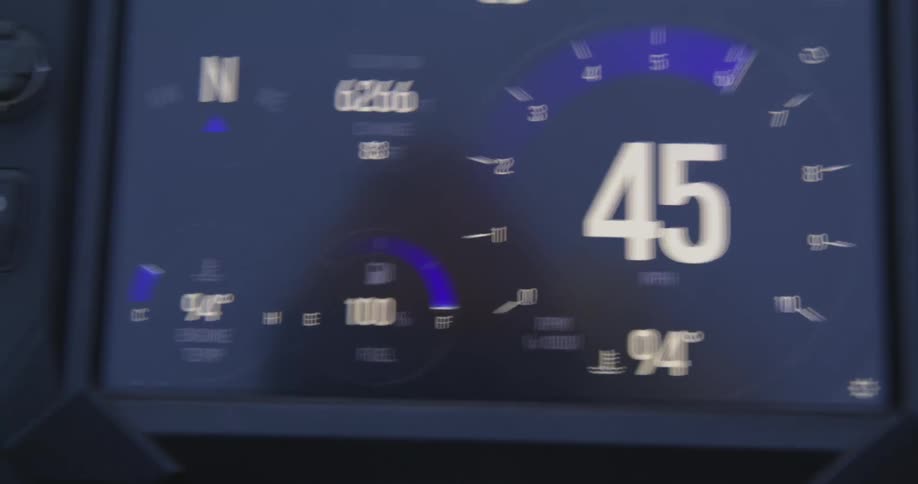 The digital dashboard of a vehicle displaying speed outside temperature fuel and oil gauges