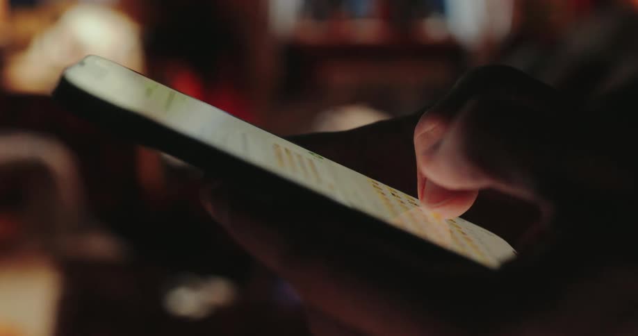A man typing with his thumbs on a smartphone screen