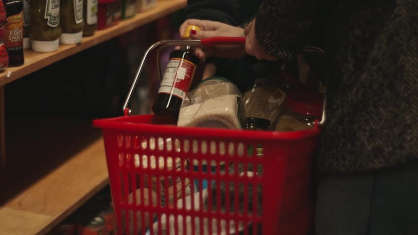 Two people are shopping for food in the grocery store