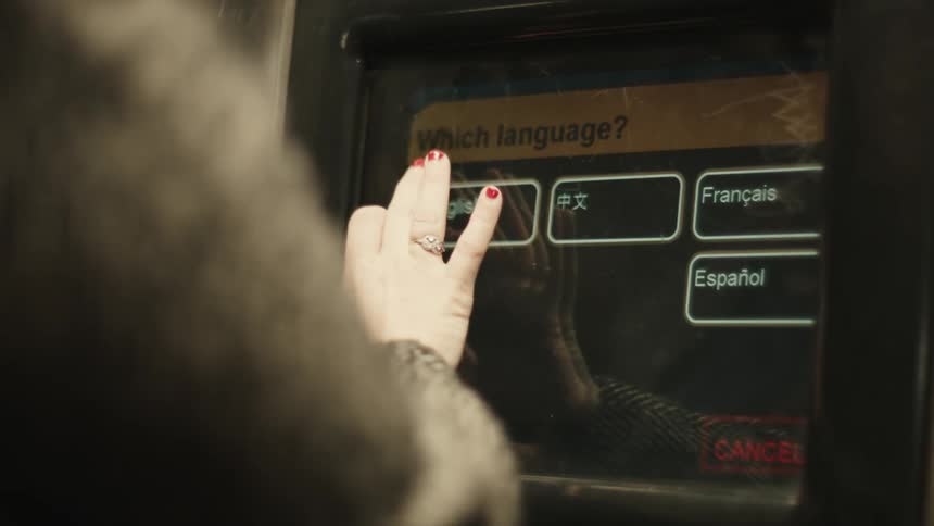 A machine with a large screen where a person is moving the screen using his fingers