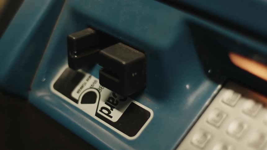 Hand inserting and withdrawing a credit card from an atm
