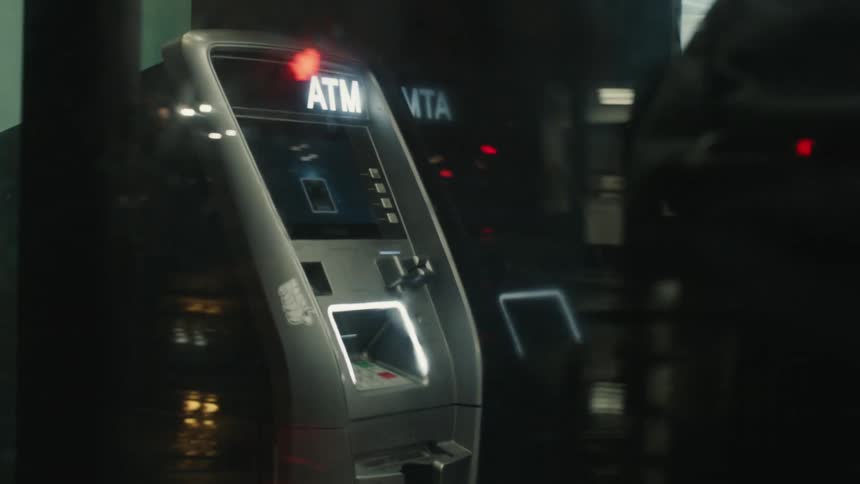 Person with backpack entering a bank with atm