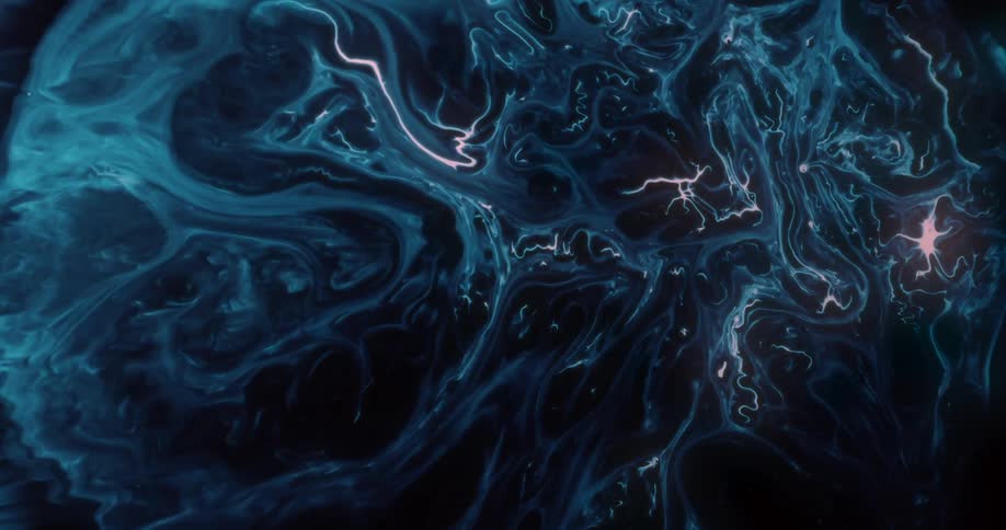 Abstract movement of pink liquid dispersing in a darker blue liquid