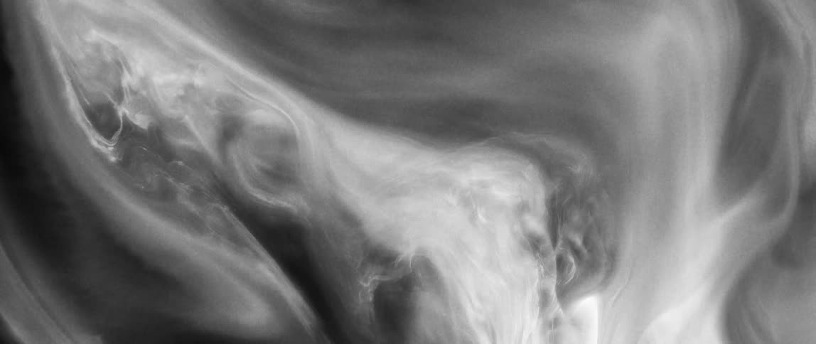 A swirling pattern of black white and gray shades resembling a fluid or smokelike texture with intricate flowing details