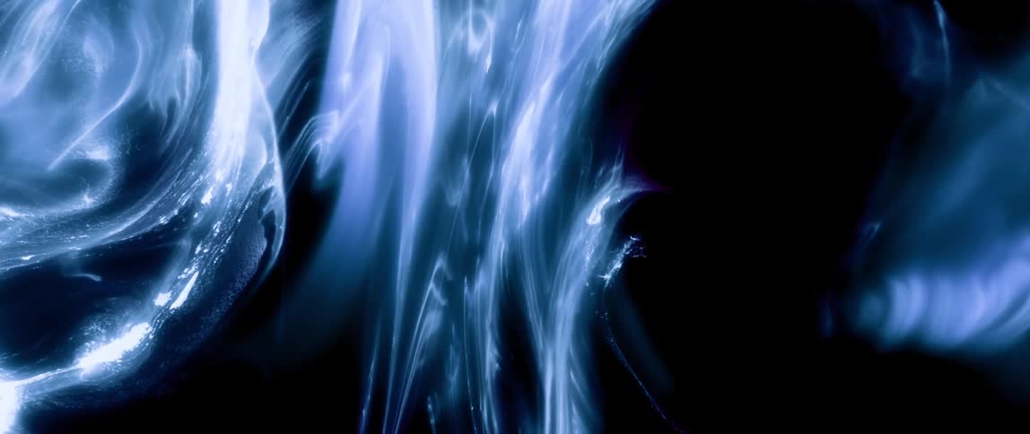 Ink droplet falling on a white surface and expanding abstractly