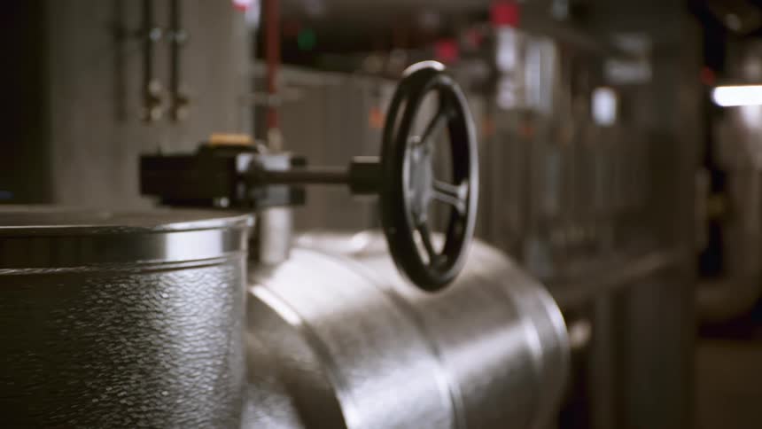 Closeup of metal valves with a large handwheel