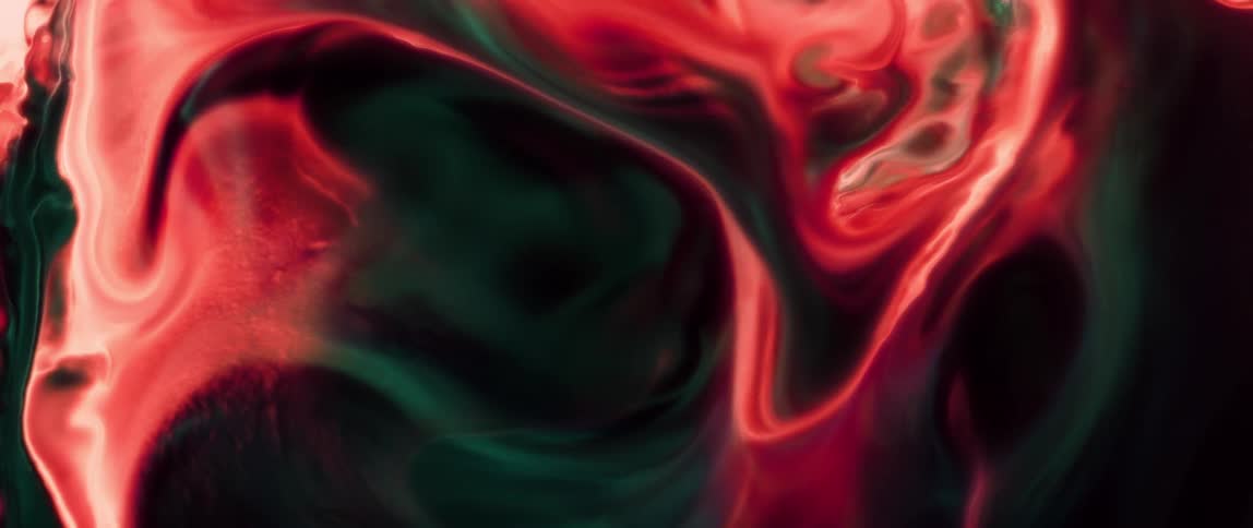 Abstract pattern of a predominantly red colored rippling liquid
