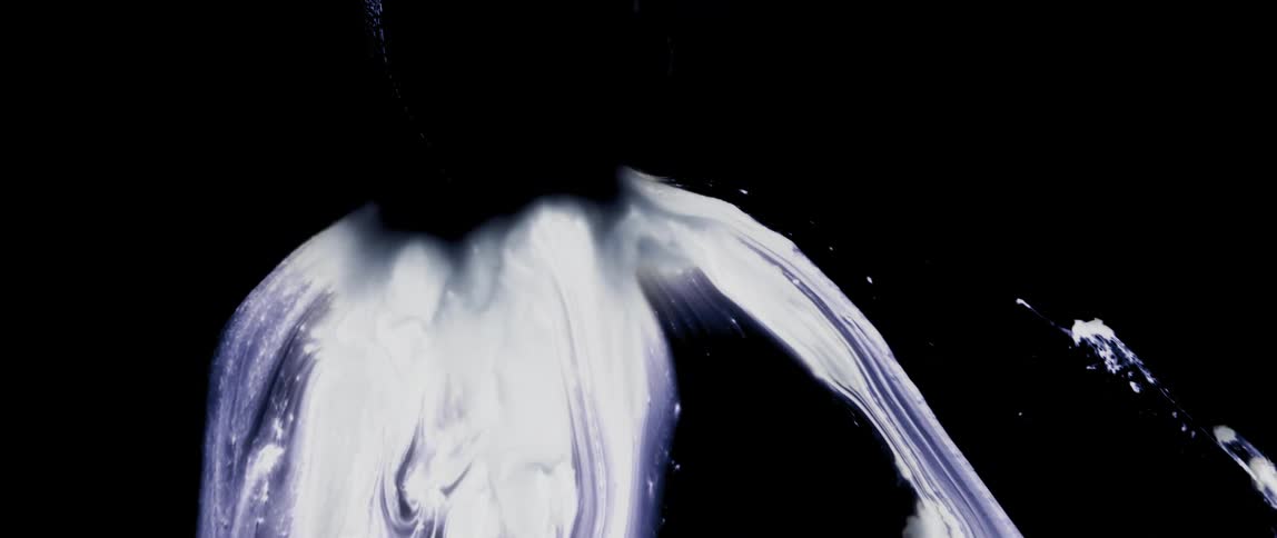 Abstract white dot dissipating on a black background