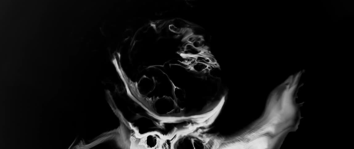 Smoke forming the outline of a human skull against a dark background