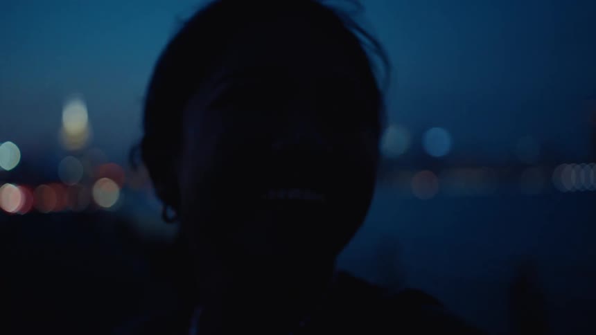 Silhouette portrait of a woman smiling outdoors at night