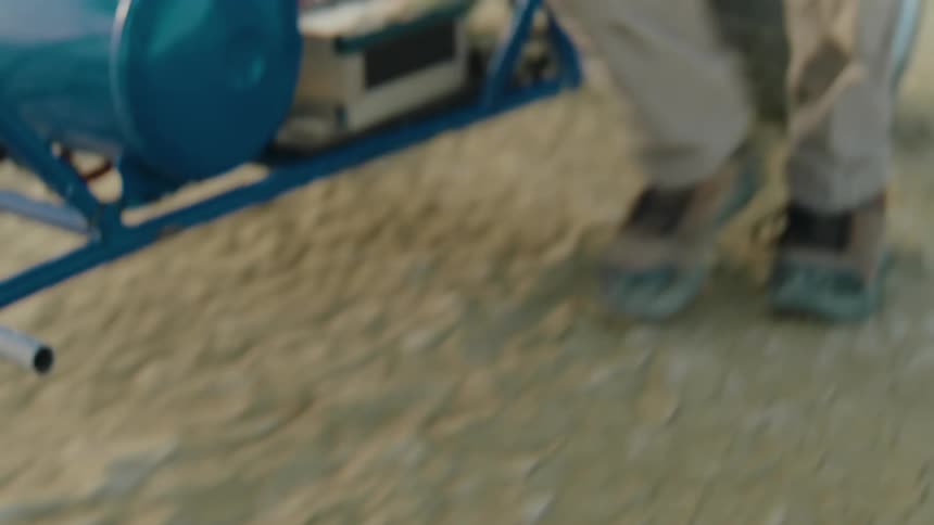 Closeup of a person walking next to a vehicle with a blue tank