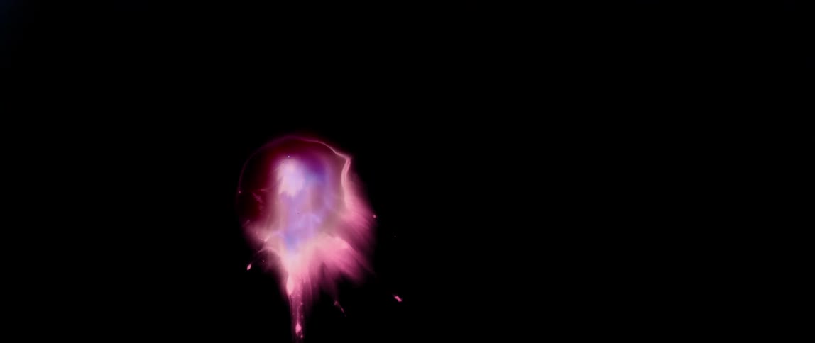 Pink color fading into an abstract black background