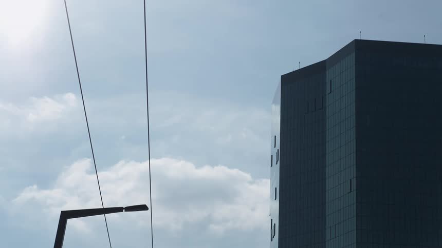 Modern mirrored building against a blue sky