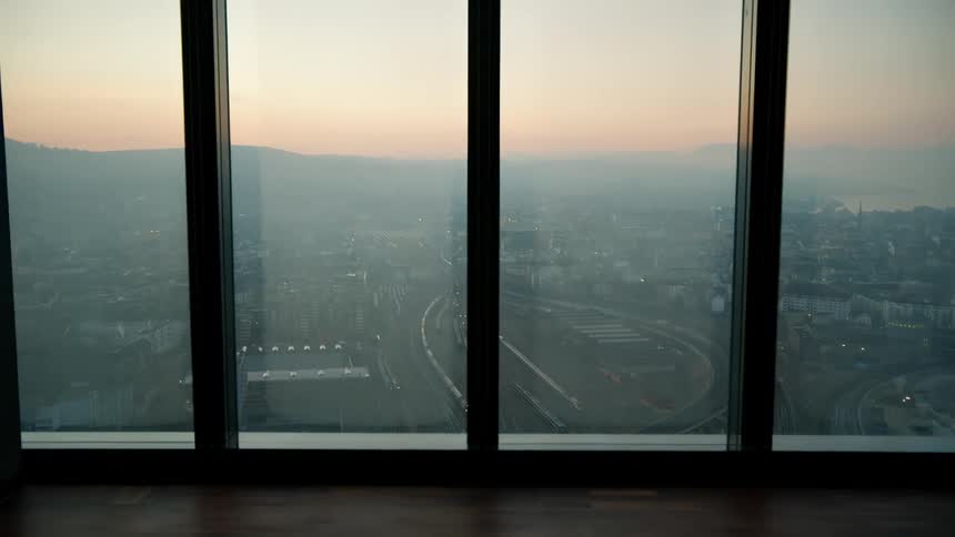 Large window with panoramic view of a city