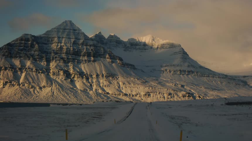 Landscape of a mountain valley covered by snow on a cloudy day