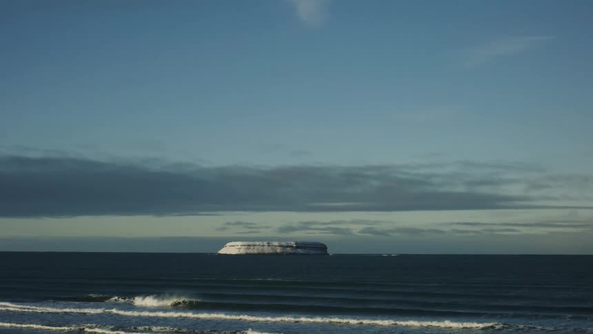Ocean landscape with a mountain in the background