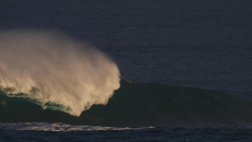 Surfer giving up on riding a wave