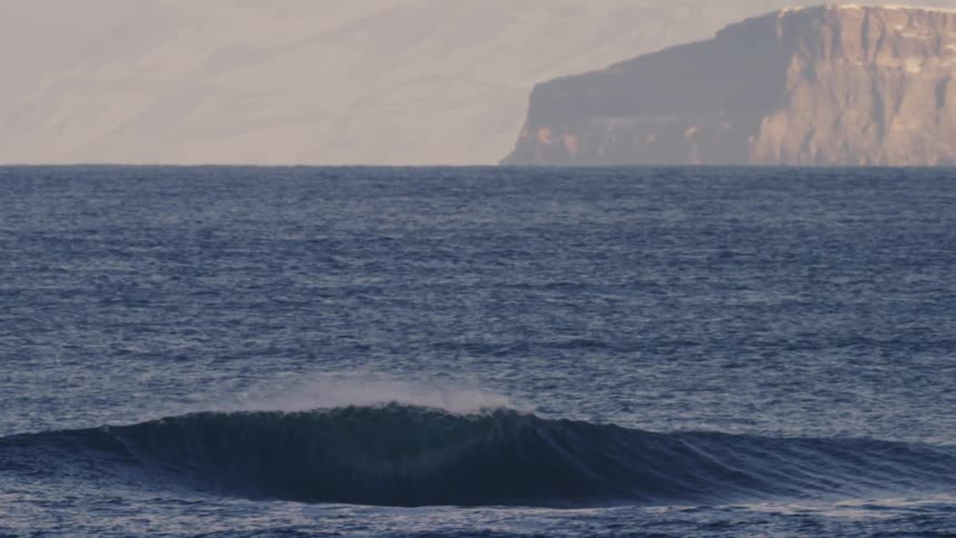 Waves are moving through the ocean in slow motion time