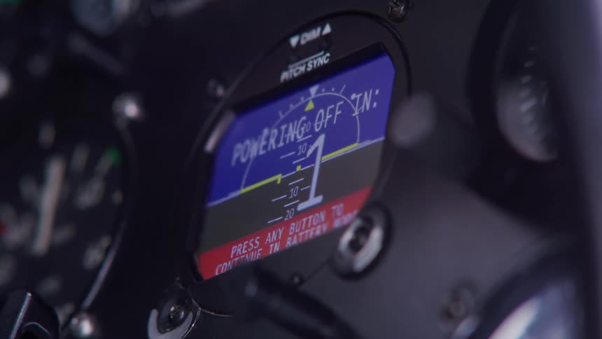 A closeup of an aircraft instrument panel with a digital display showing a countdown