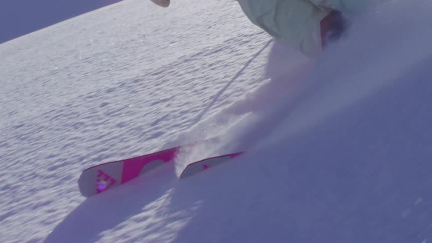 Person sliding and skiing on a snowy mountain