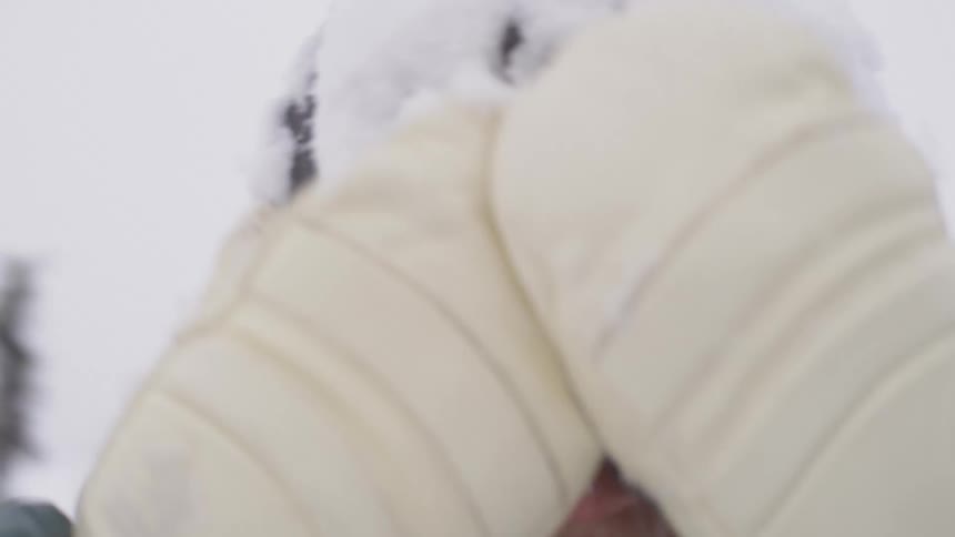 Portrait of a smiling woman with snow on her face