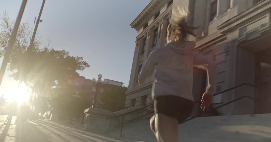 Woman running at high speed on the sidewalk