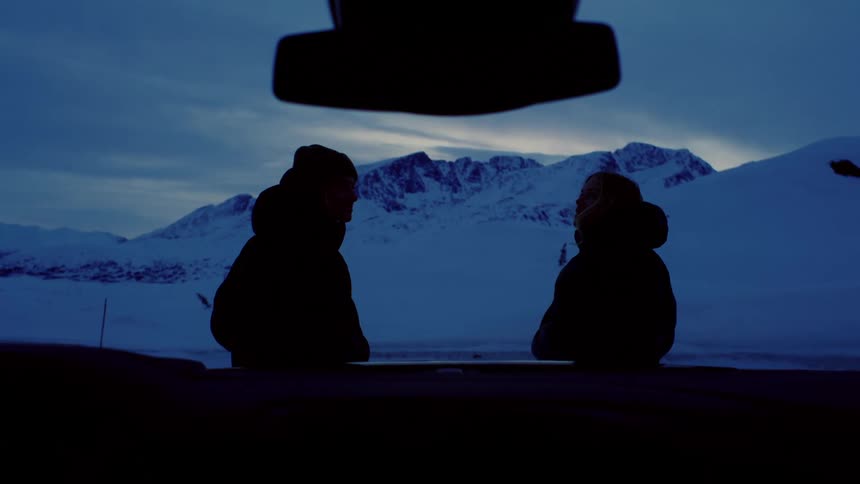 A clip of two people standing outdoor in the arctic