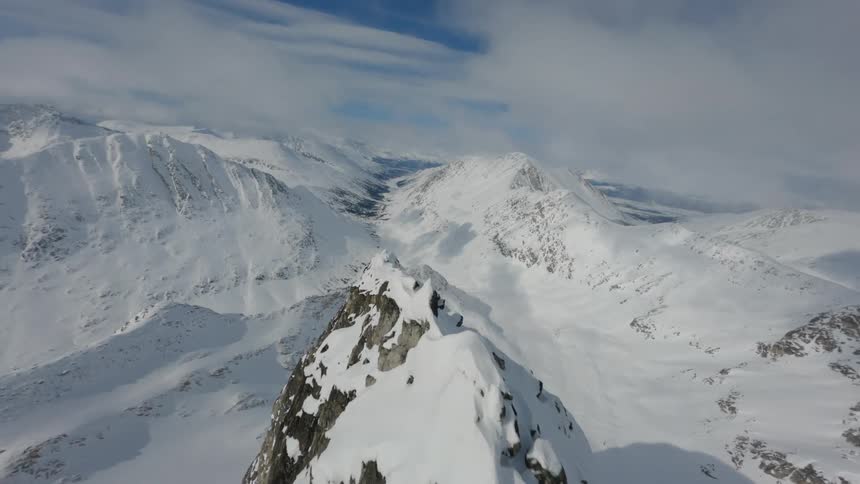 Snow is covering the mountains and surrounding landscape