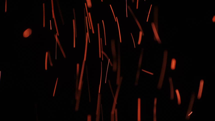 A flame gives off sparks at night